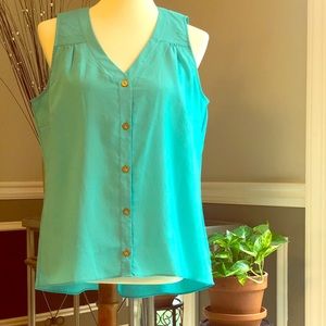 Teal green sleeveless blouse.